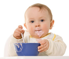 Toddler eating you from a blue bowl